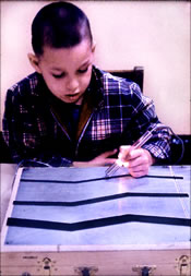 Figure 6.  Child at the Kennedy Memorial Hospital in Brighton, Massachusetts practicing  hand-eye coordination with the rehabilitation toy 