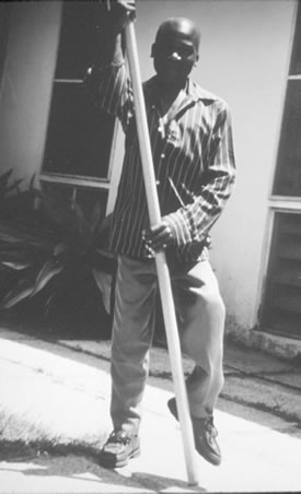 Figure 1. This photograph, taken by Ren Baumgartner, MD, in Tanzania in 1993, shows a man with an impairment (paralysis of left leg from polio) who uses a simple assistive aid for walking. The aid is similar to one used in Egypt around 1500 B.C.E. as recorded on an ancient Egyptian stele that is now in the Carlsberg Sculpture Museum in Copenhagen.